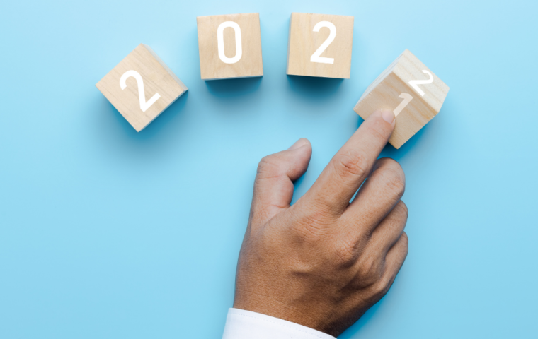 Hand of business people turn 2021 to 2022 on cube box