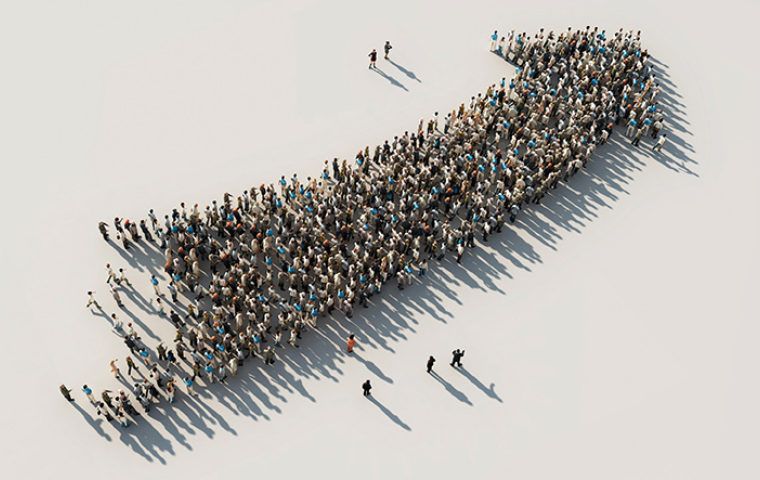 Crowd of people forming the shape of an upwards arrow