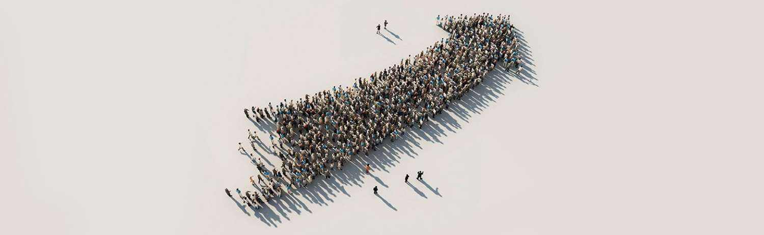 Crowd of people forming the shape of an upwards arrow