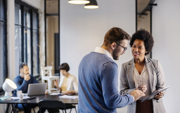 I Stock FAS Guide Business professional providing advice standing with a tablet