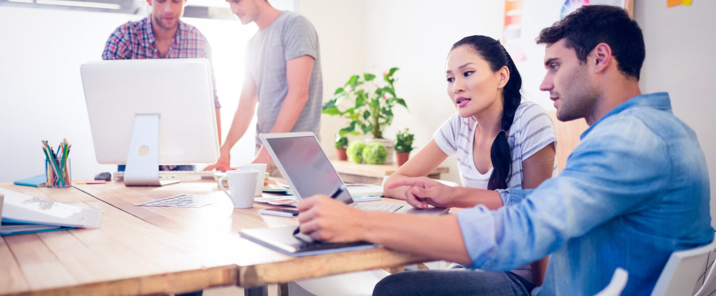 I Stock Business Explorer two professionals planning a new innovative product on a laptop