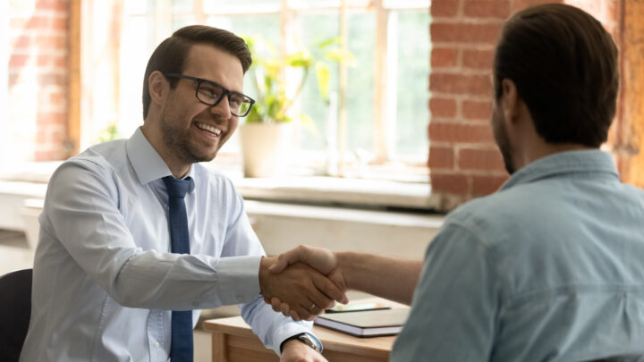 I Stock EAS business professionals shaking hands at meeting