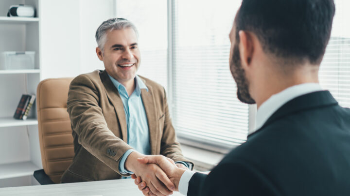 I Stock SEIS EIS two business professional shaking hands both satisfied with negotiations