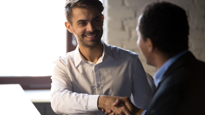 I Stock Trade Hub smiling business professionals after negotiation