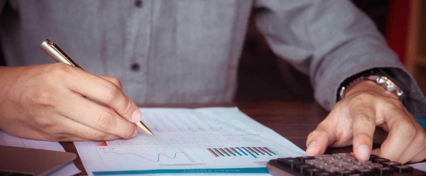 Man Working with Calculator to Calculate Numbers