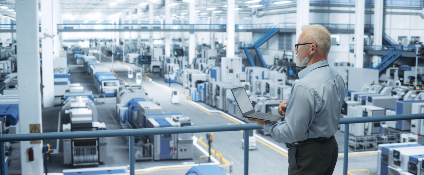 I Stock Business Engineer in tech factory with laptop