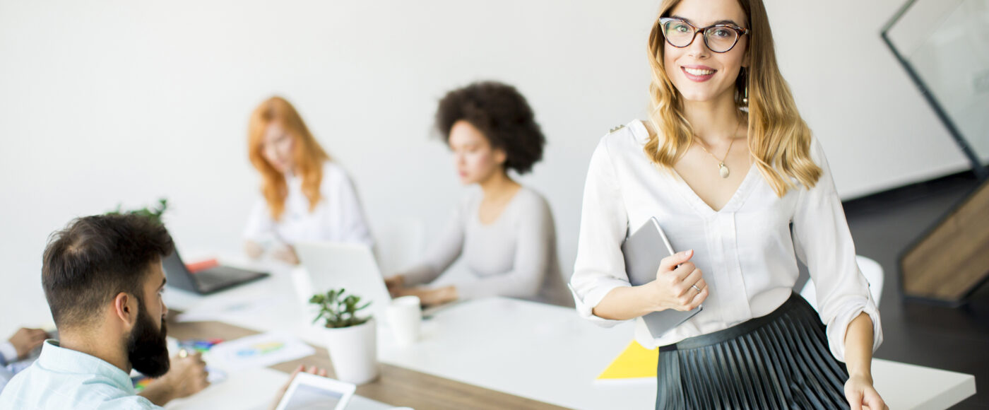 I Stock Diversifying products and processes smiling business professional in innovative team meeting