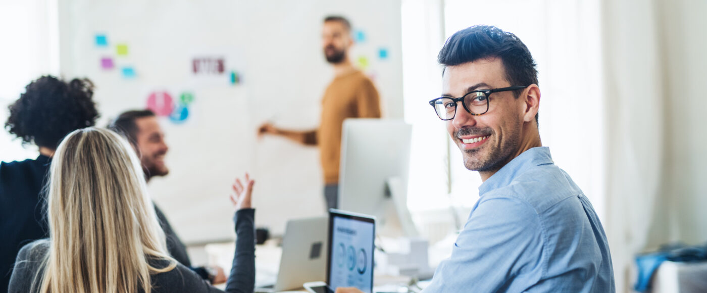 I Stock EAS smiling business person in meeting room