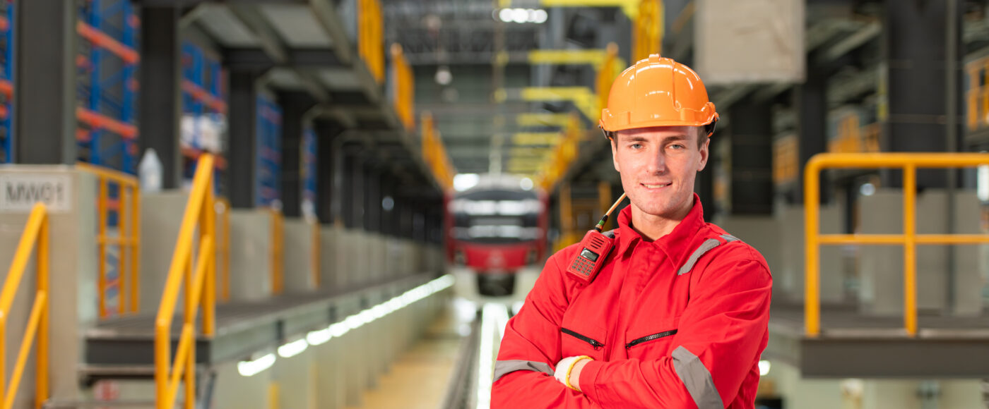 I Stock Export Trade Help factory worker standing infront of machine controls