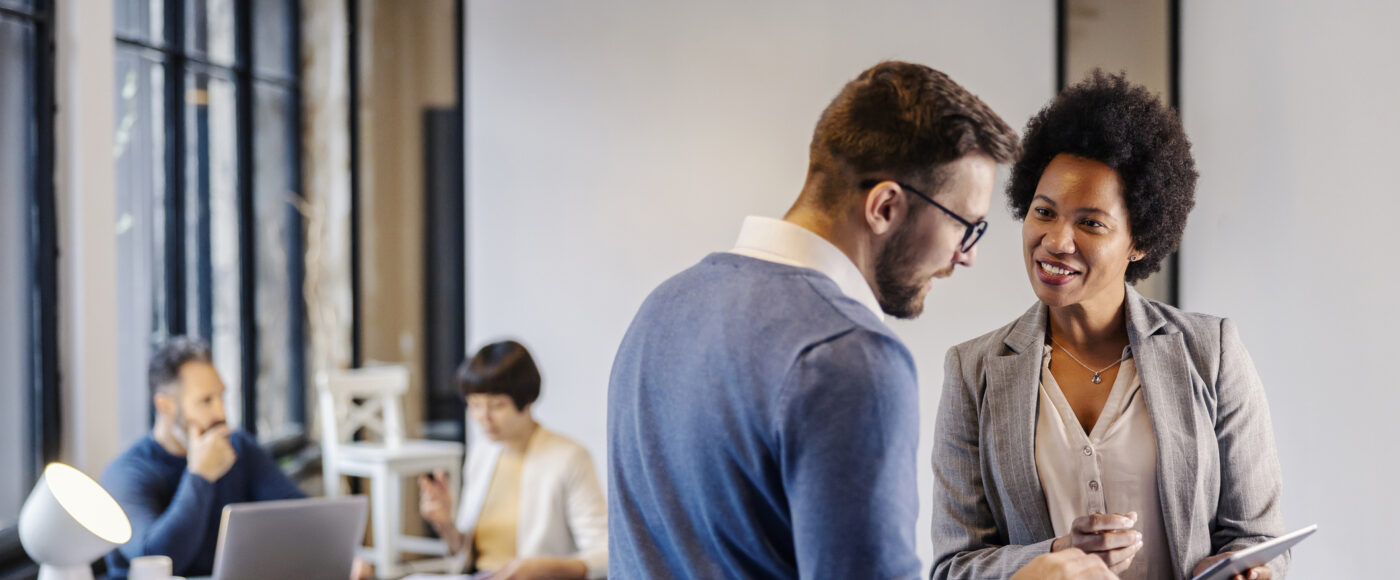 I Stock FAS Guide Business professional providing advice standing with a tablet