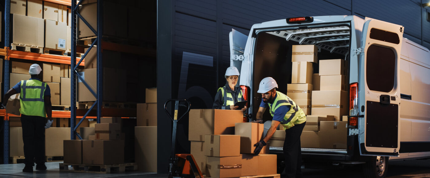 I Stock First Time Exporters two warehouse staff unloading van