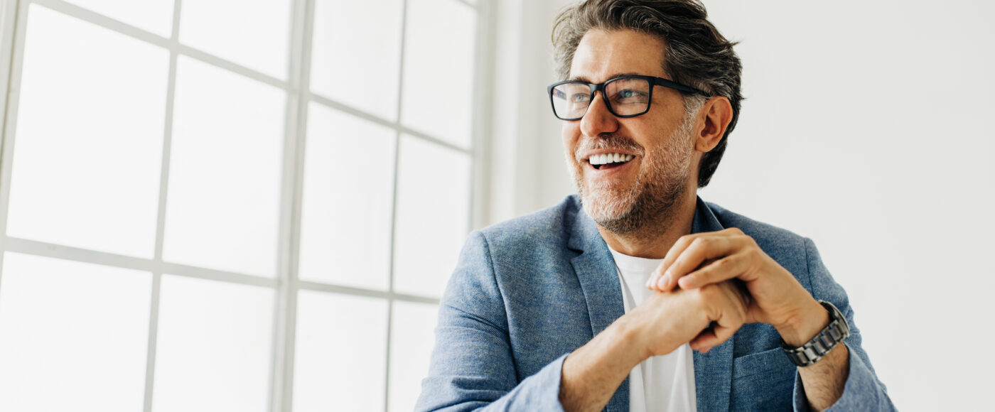 I Stock SEIS Smiling business profressional sitting with blue suit