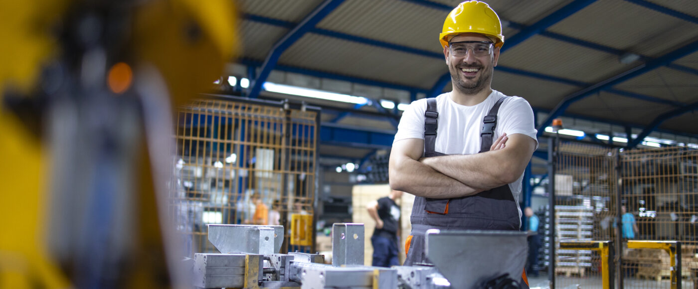 I Stock Trade hub standing warehouse worker with arms crossed