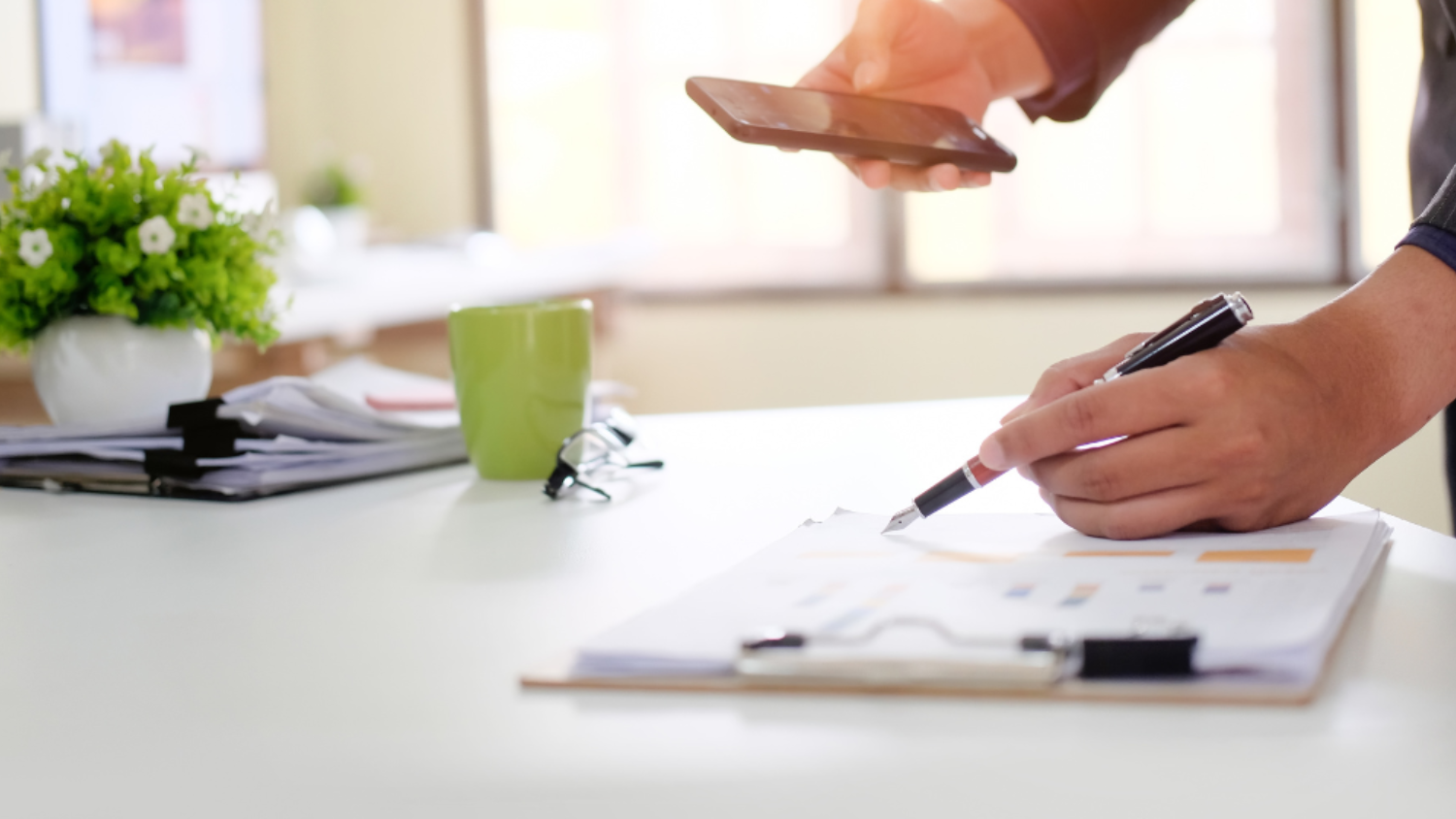 Businessman checklist on chart board paper working on table