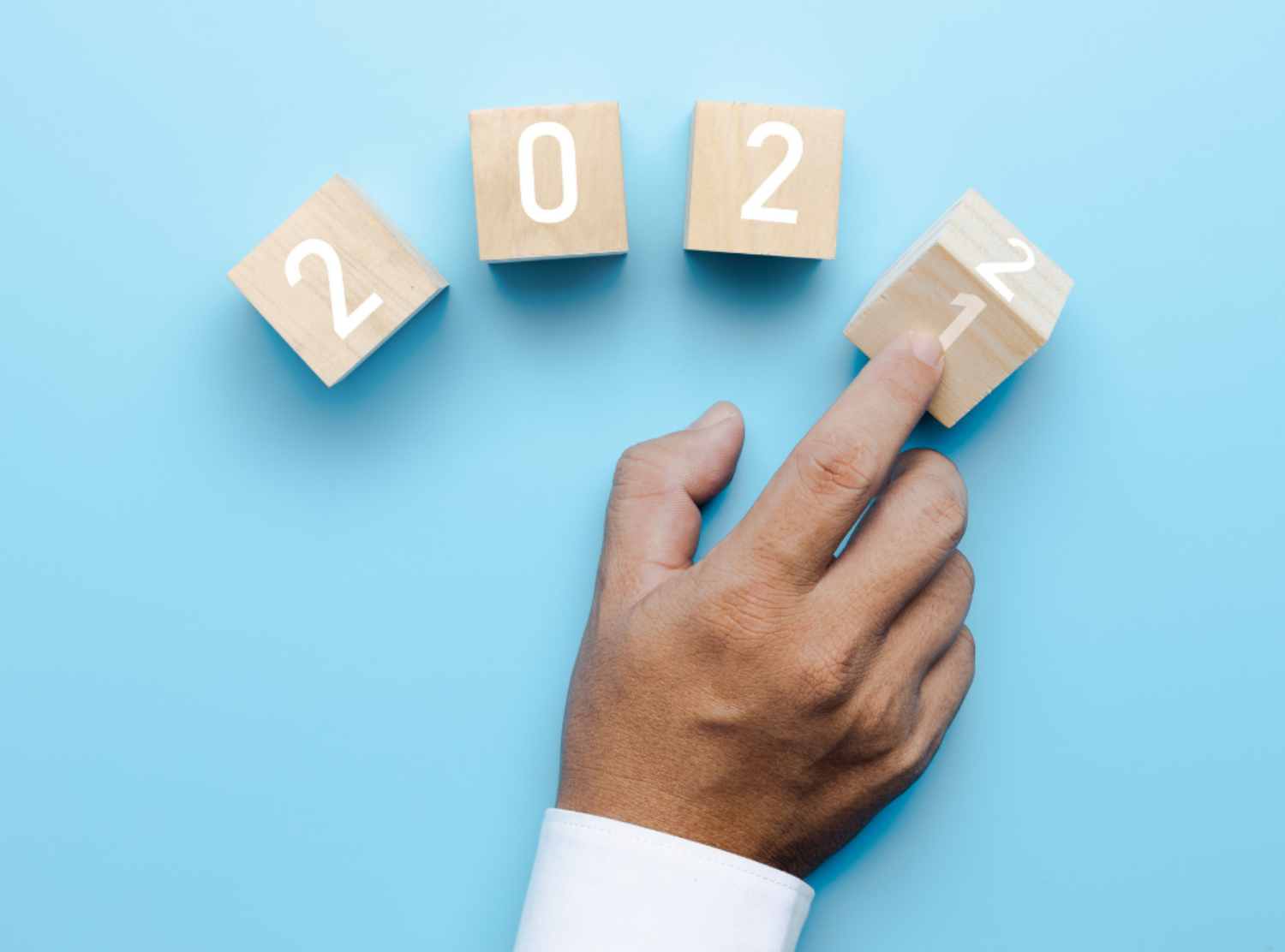 Hand of business people turn 2021 to 2022 on cube box