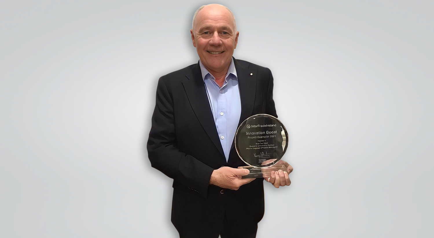 Joe English holding his award landscape