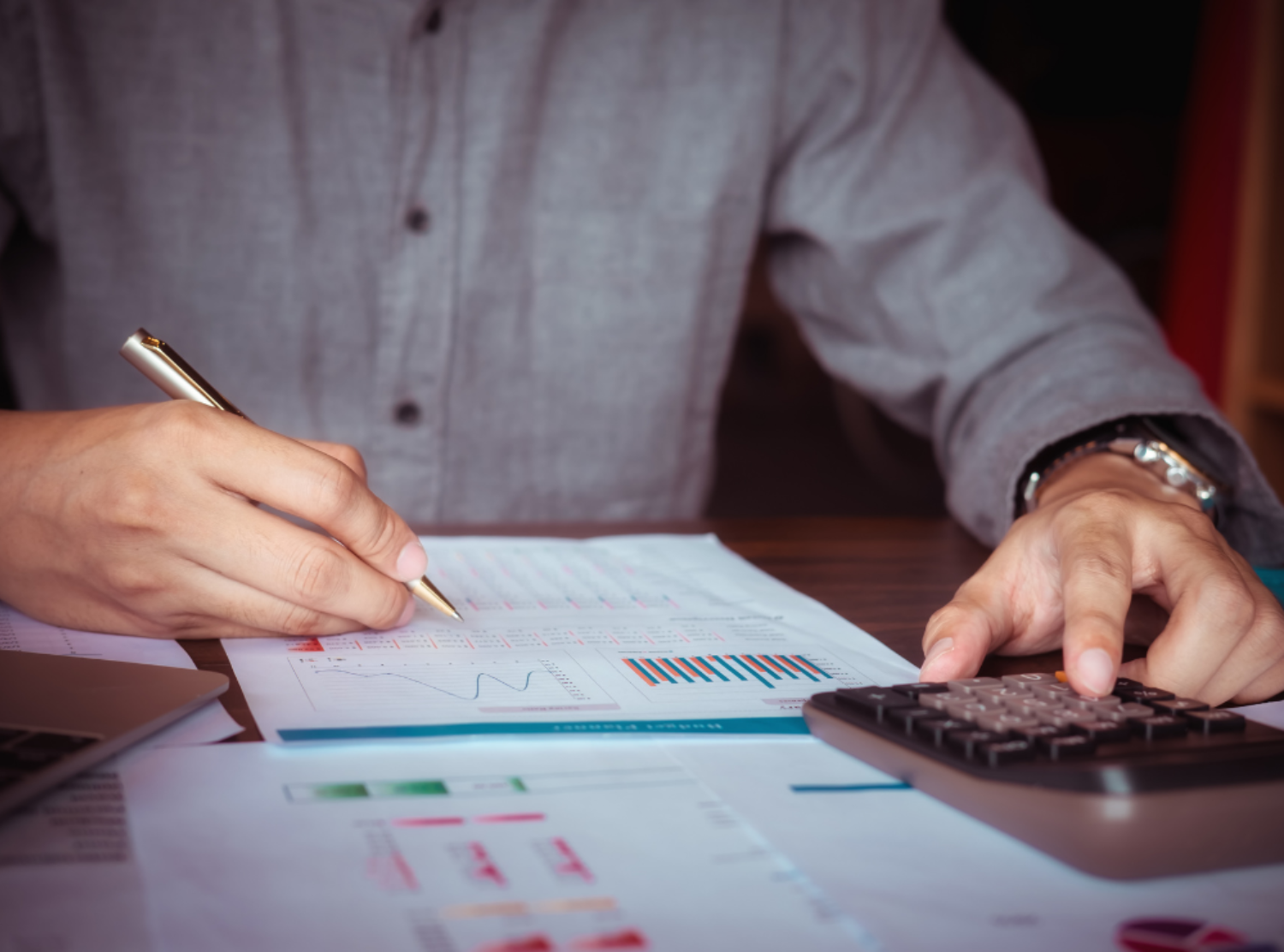 Man Working with Calculator to Calculate Numbers
