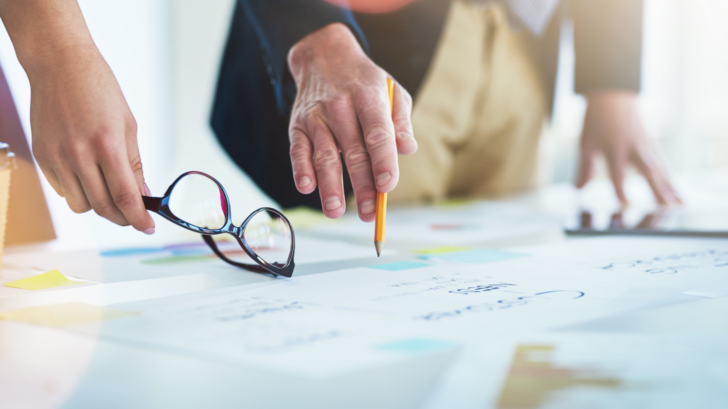 Employees pointing at business plans to scale business