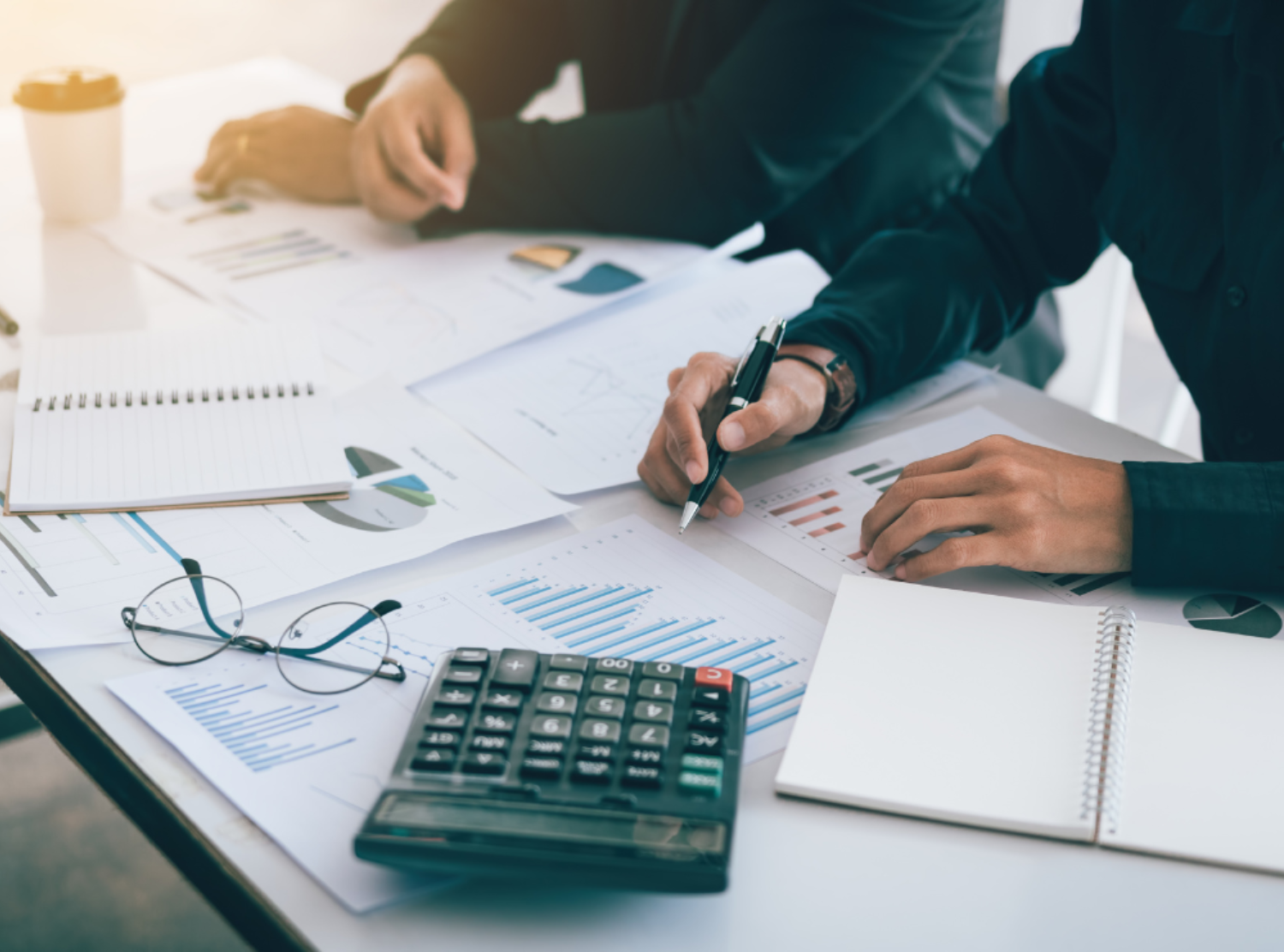 Two Business People calculating charts