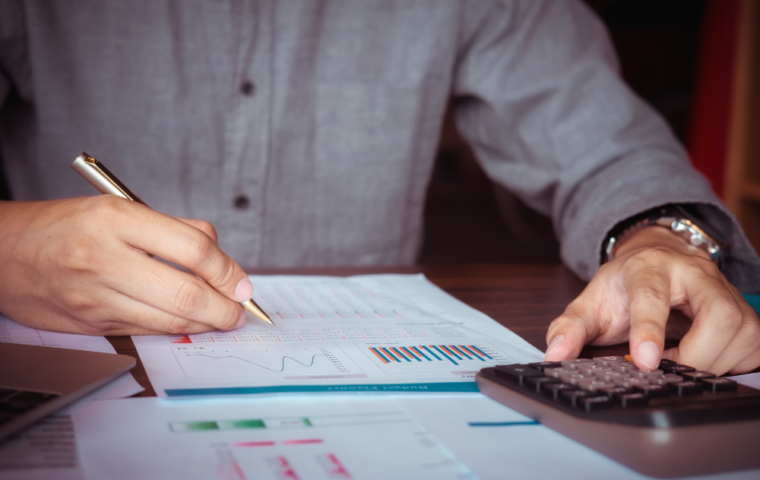 Man Working with Calculator to Calculate Numbers