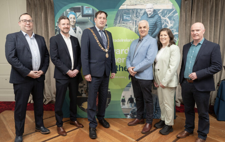 People standing infront of an Inter Trade Ireland banner